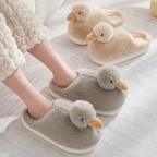 Grey duckling slippers being worn alongside cream duckling slippers