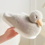 Close-up grey duckling slipper with fluffy texture and duck face