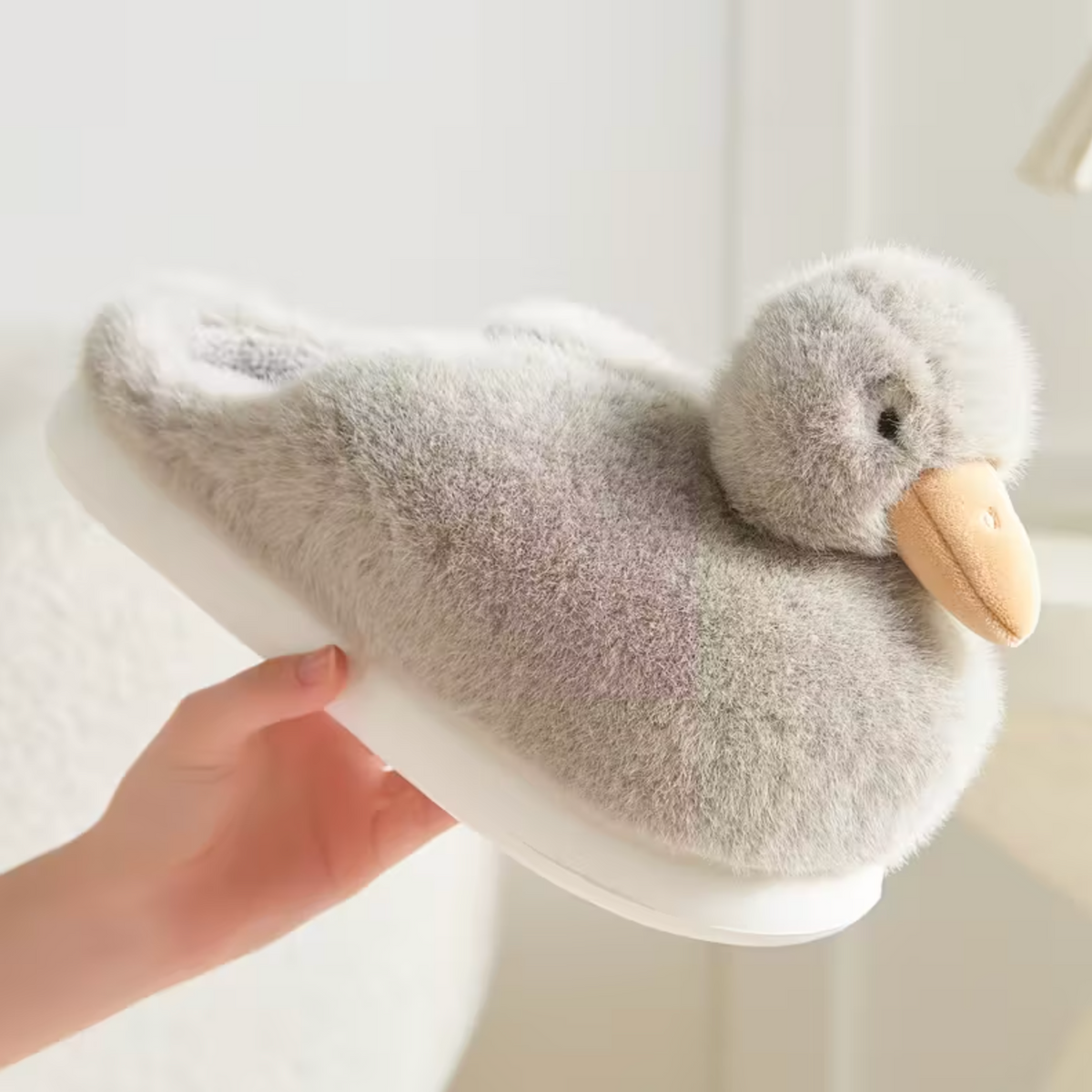 Close-up grey duckling slipper with fluffy texture and duck face