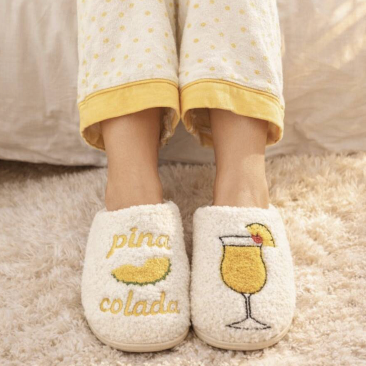 White Pina Colada slippers with pineapple cocktail embroidery being worn at home