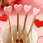 Gold four-piece heart-handle cutlery set with two spoons and two forks