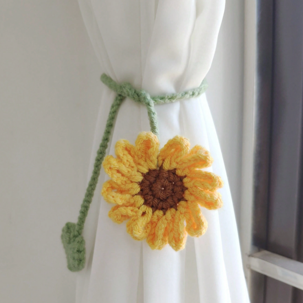 Purple crochet flower bookmark displayed in an open notebook