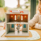 White wooden castle play set with blue towers, red handle and removable moat pieces