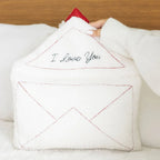 Love Letter Embroidered Boucle Cushion on white background showing the full envelope shape with red topstitching and raised red satin heart