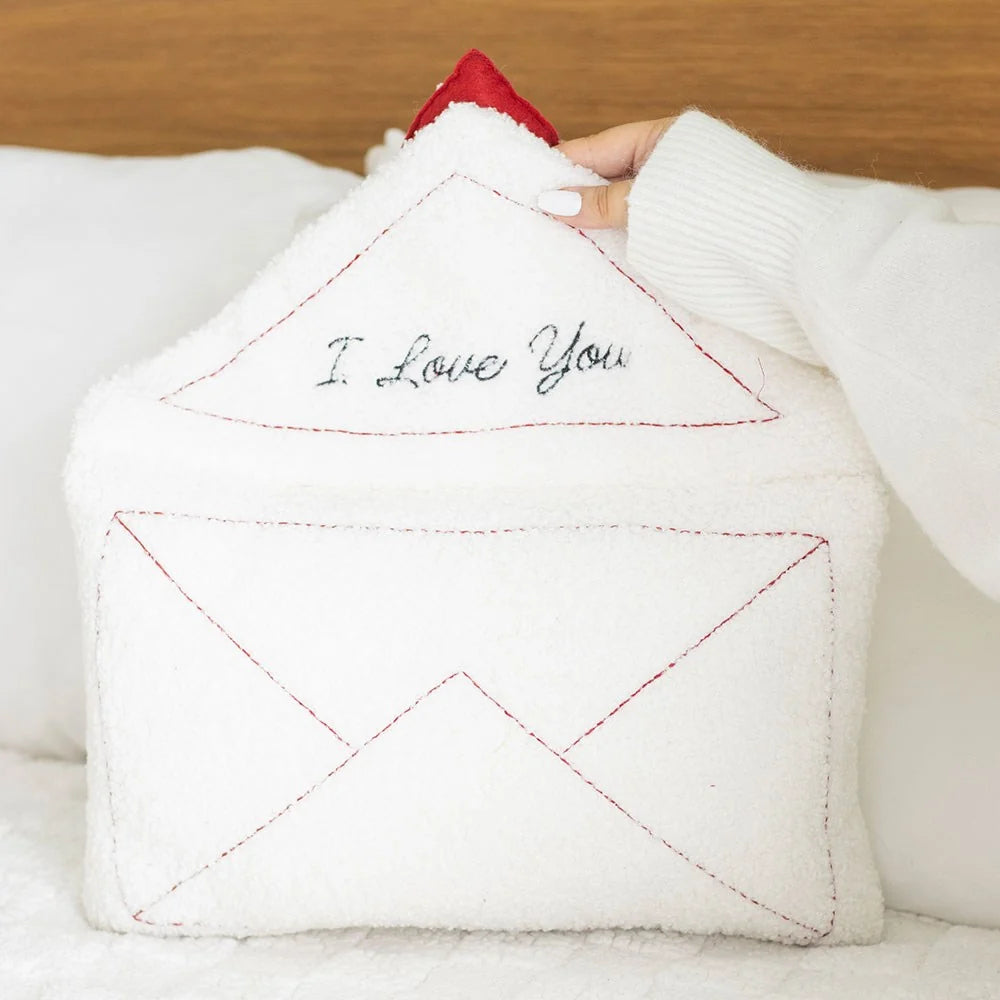 Love Letter Embroidered Boucle Cushion on white background showing the full envelope shape with red topstitching and raised red satin heart