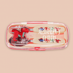 A children's cutlery set in a clear plastic case with red trim, featuring dinosaur-themed handles and utensils, shown on a solid beige background. The text 'ALEXANDER'S CUTLERY' is overlaid on the image.