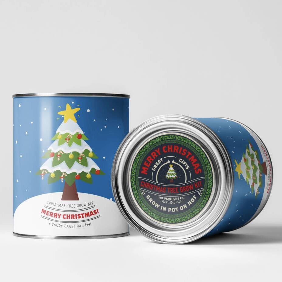 Two blue cylindrical metal tins with Christmas tree illustrations, one standing upright and the other lying on its side to show the lid label, on a light gray background.