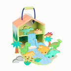 A colorful wooden dinosaur playset featuring a small house with a handle, a waterfall, palm trees, and multiple wooden dinosaur figures in green, orange, yellow, and blue, shown on a plain white background.