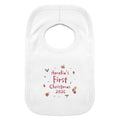 A white baby bib with a personalized Christmas print reading 'Amelia's First Christmas 2026' in red, surrounded by small festive illustrations, shown on a plain white background.