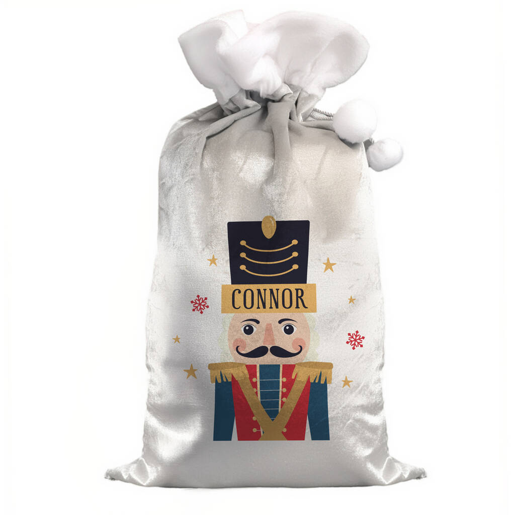 White gift bag with a nutcracker design and 'Connor' text on a white background
