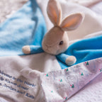 Peter Rabbit comforter with embroidered three-line personalised message beside the Peter Rabbit label